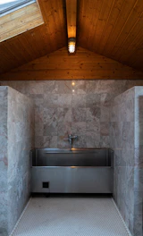 Close-up of a custom handmade tile sink with elegant stone texture in a refined bathroom.