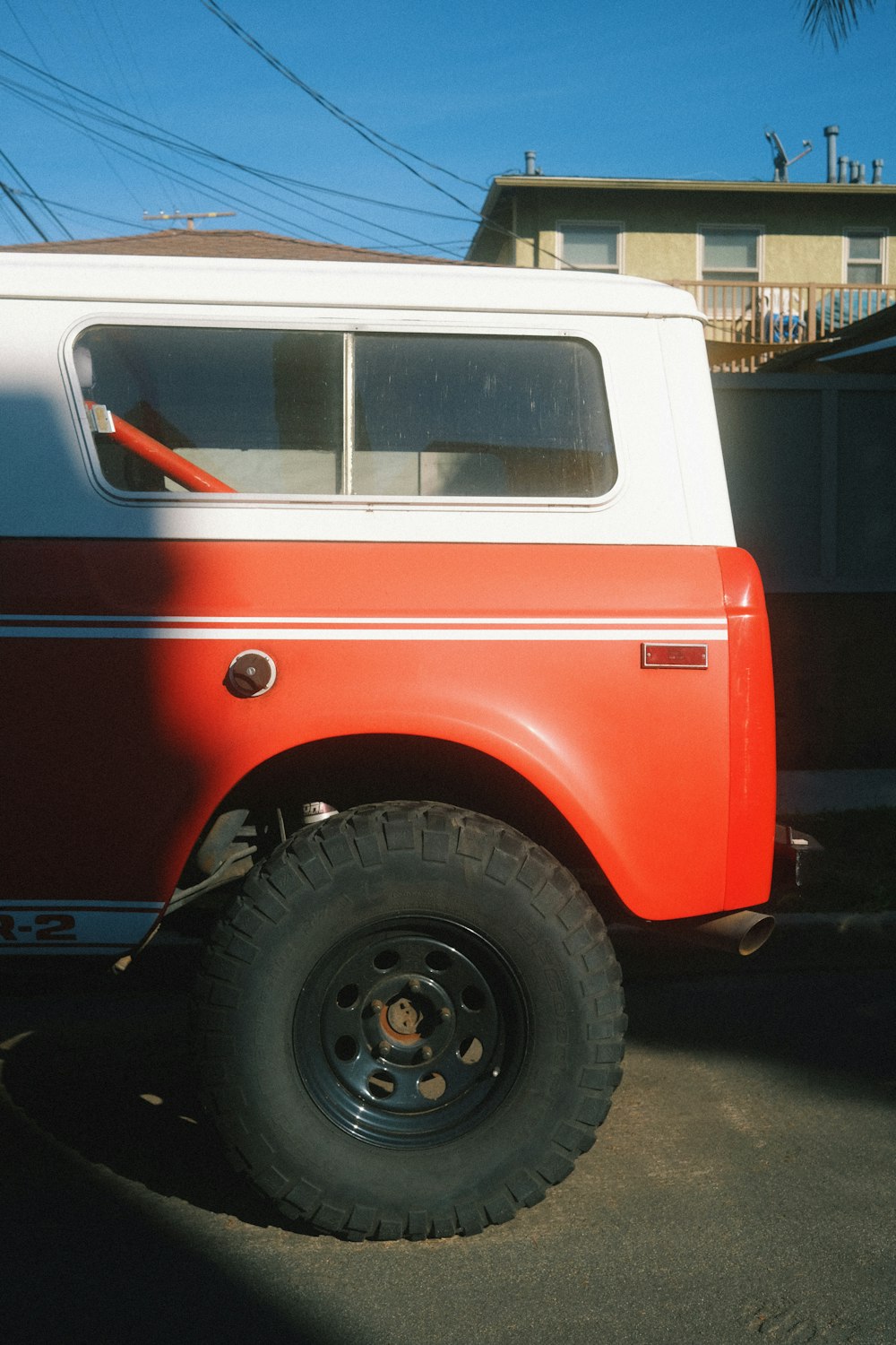 a red and white truck parked in a parking lot