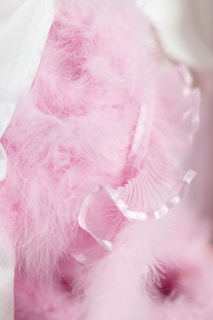 Close-up of a delicate pink baby bow with soft fabric texture