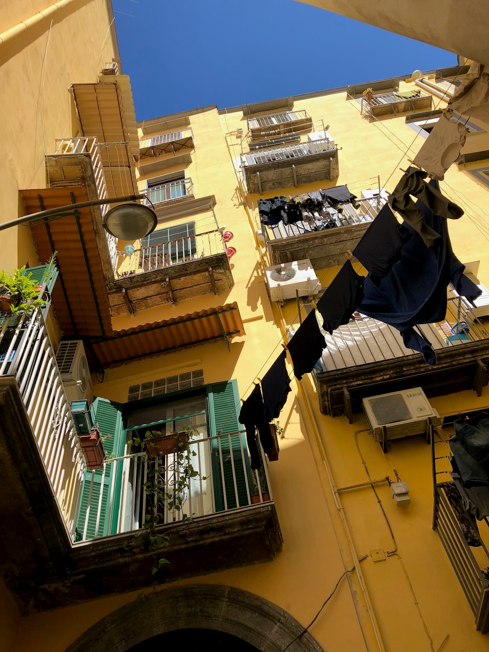 a building with a bunch of clothes hanging from it's balconies