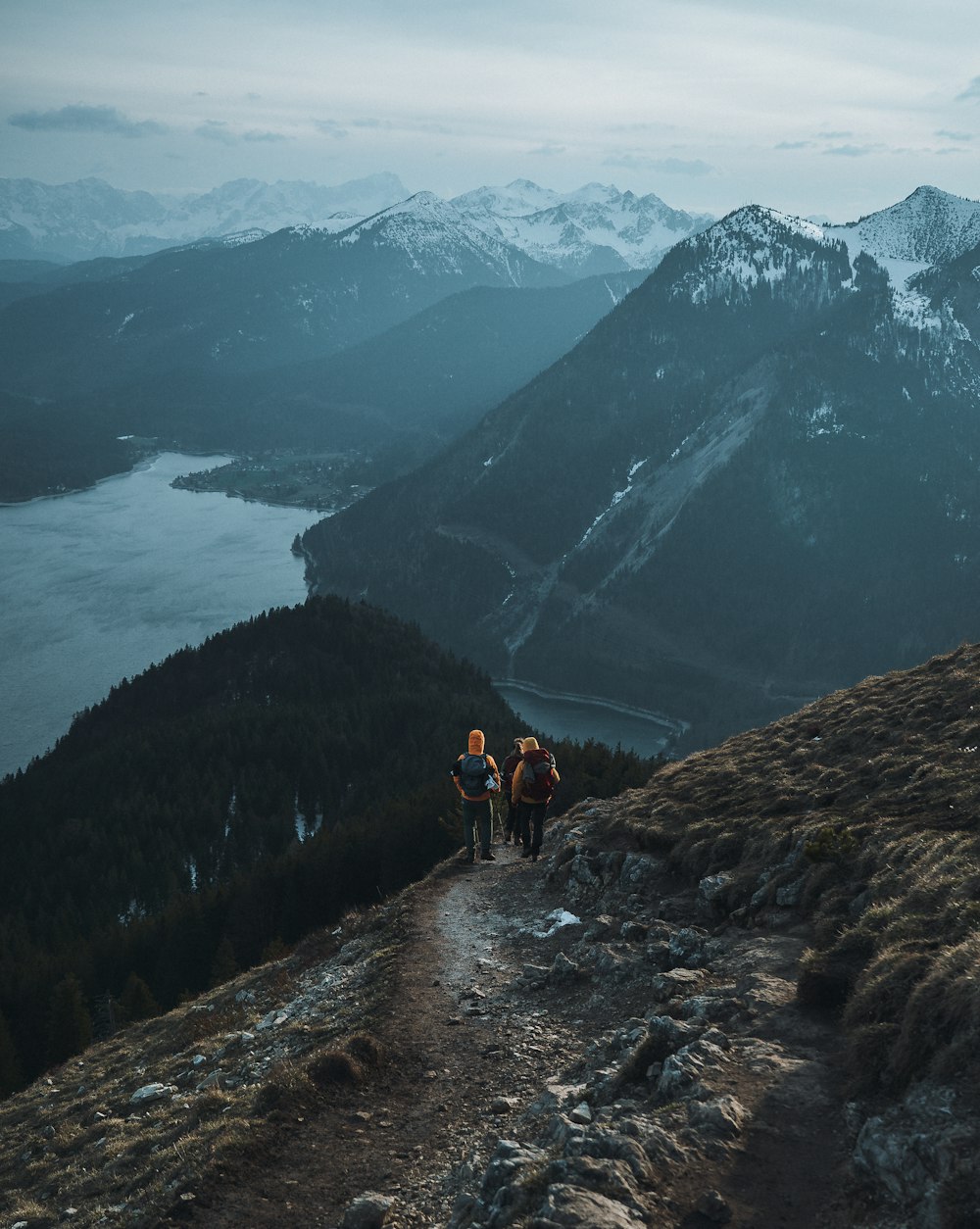 a couple of people that are standing on a hill