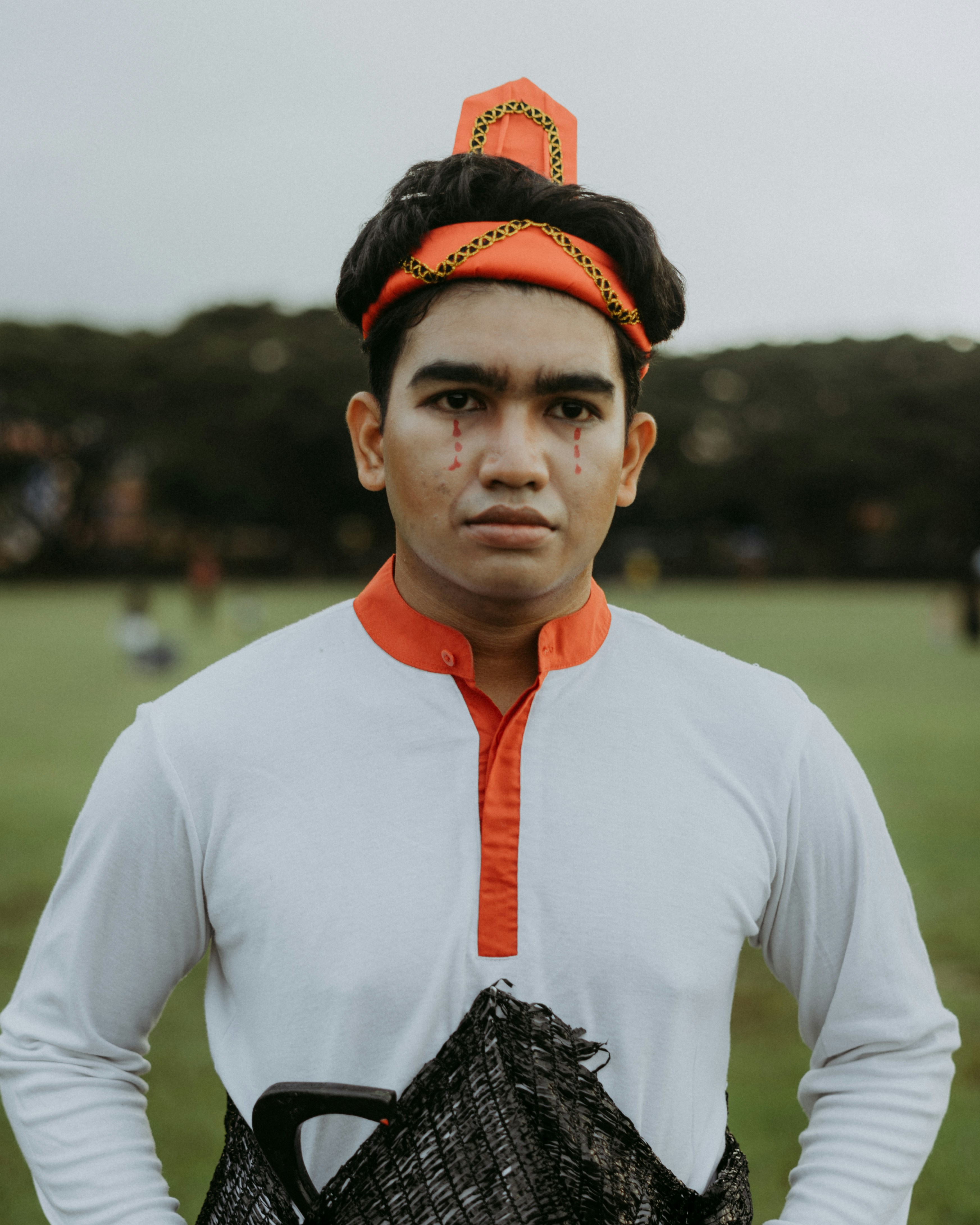 a man in a white shirt holding a black basket