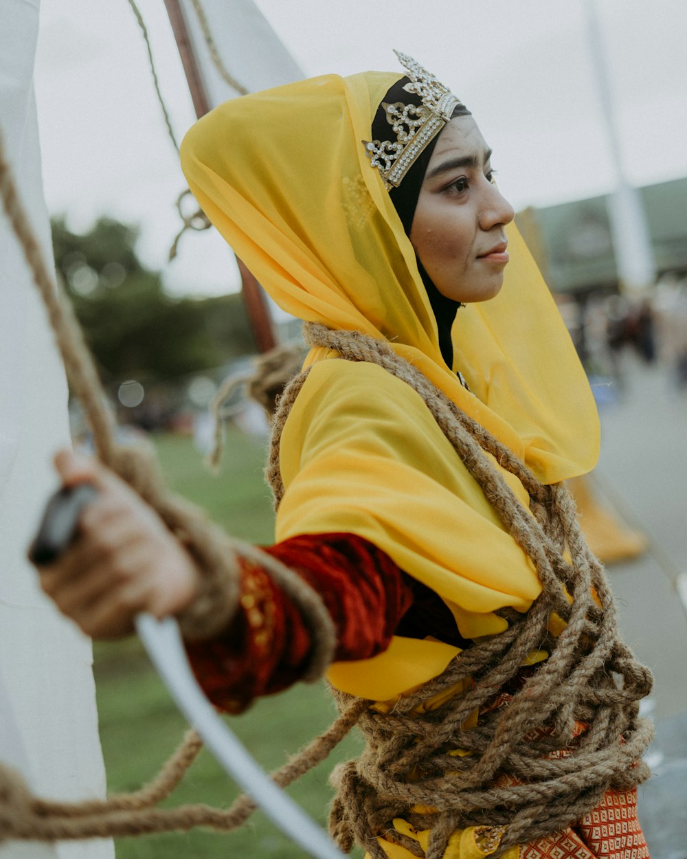 a woman dressed in a costume holding a sword