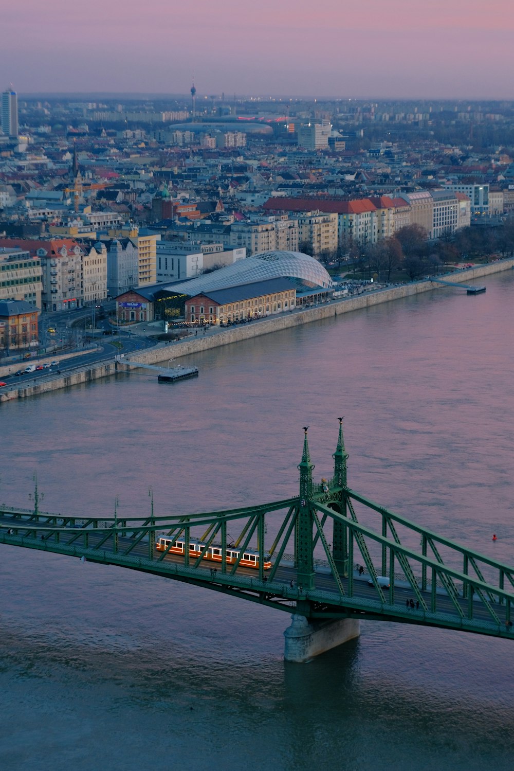 a bridge over a body of water with a train on it