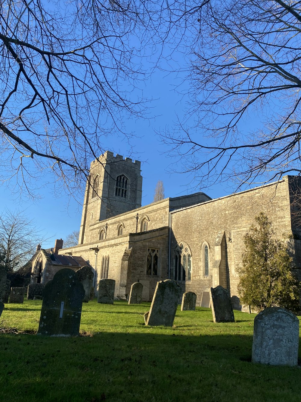 an old church with a graveyard in the foreground