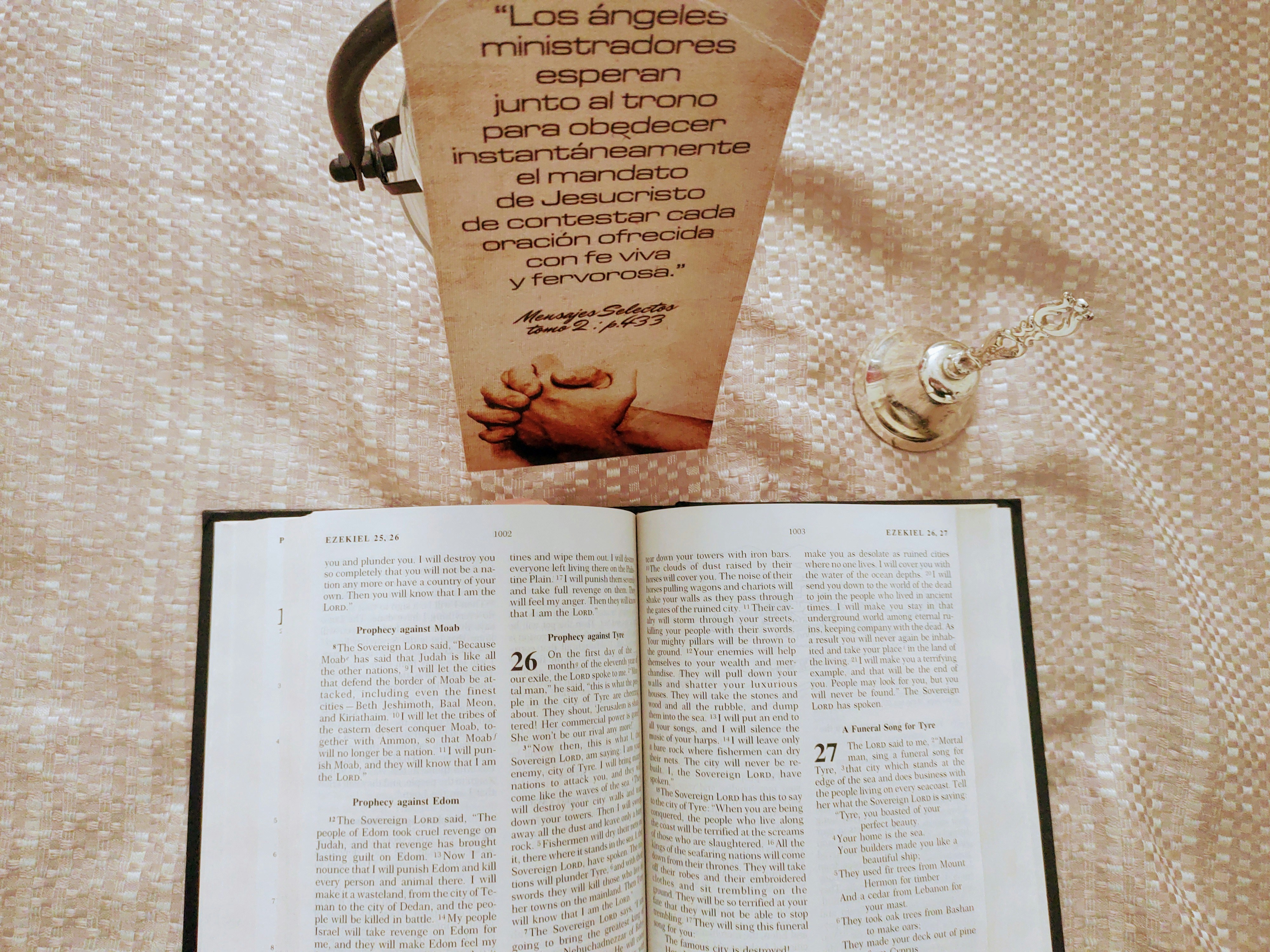a book opened on top of a bed next to a pair of scissors