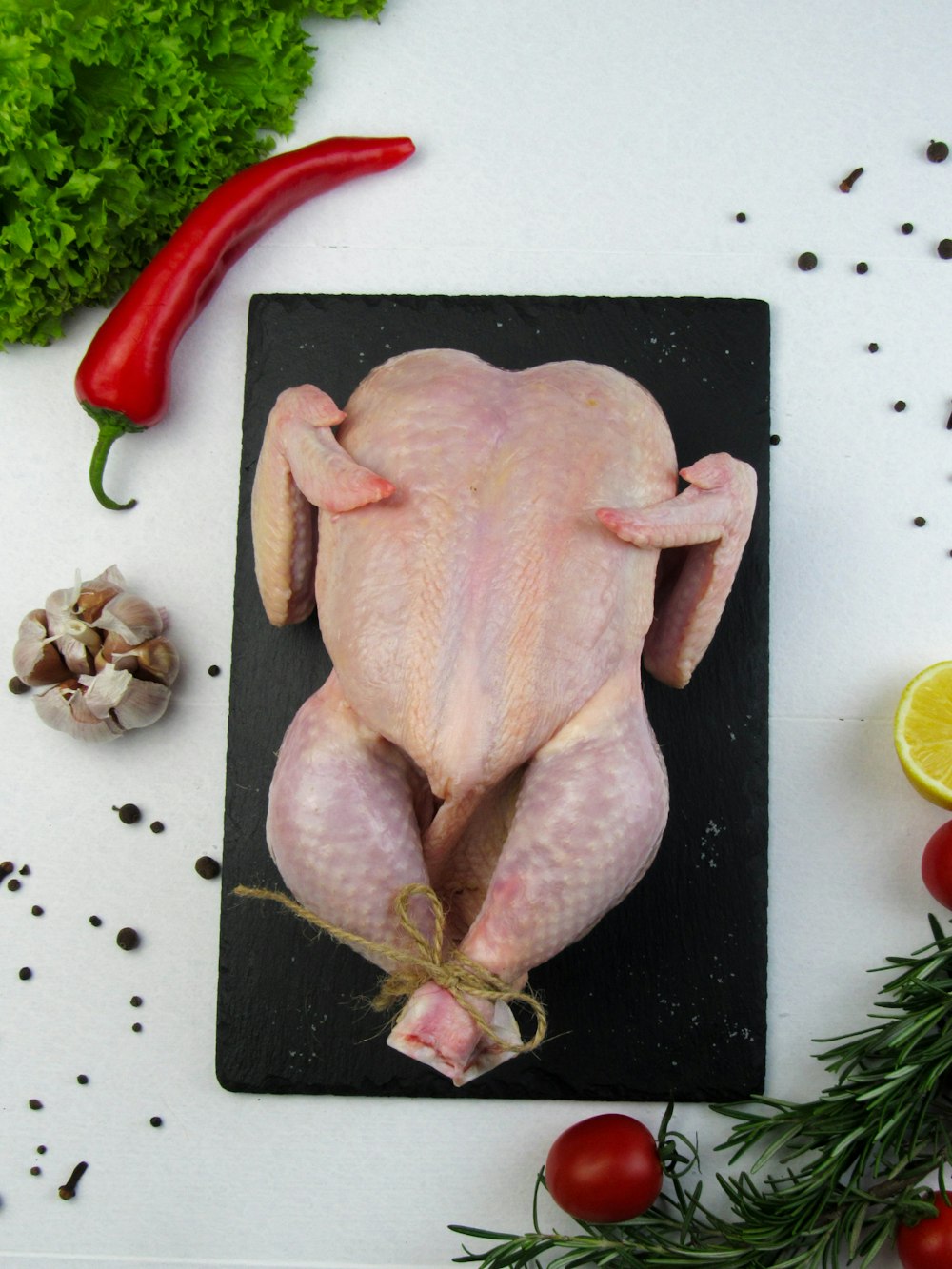a raw chicken sitting on top of a cutting board
