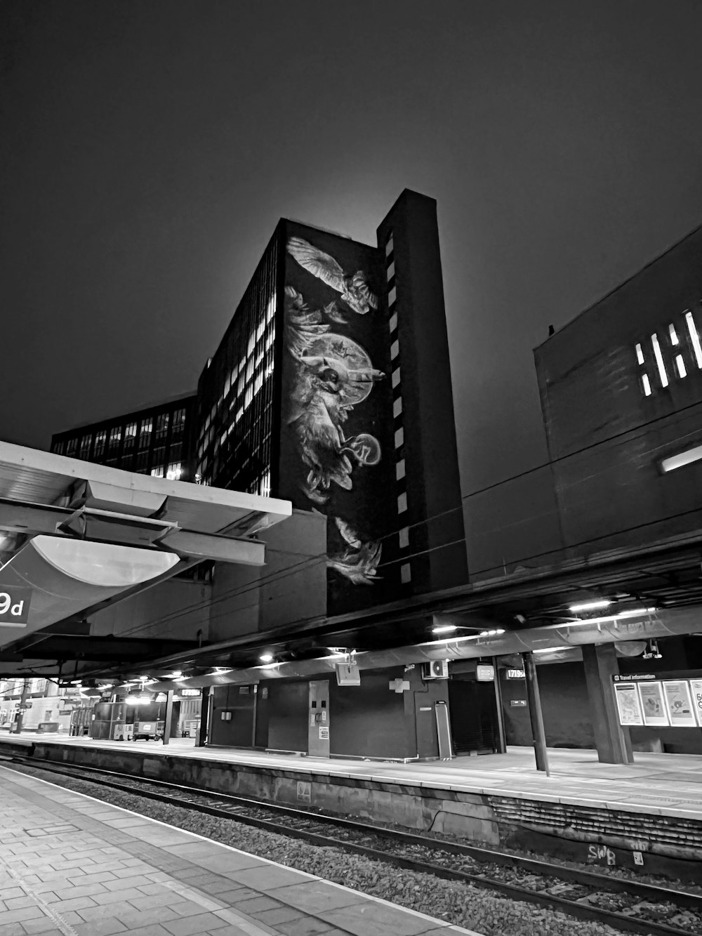 a black and white photo of a train station