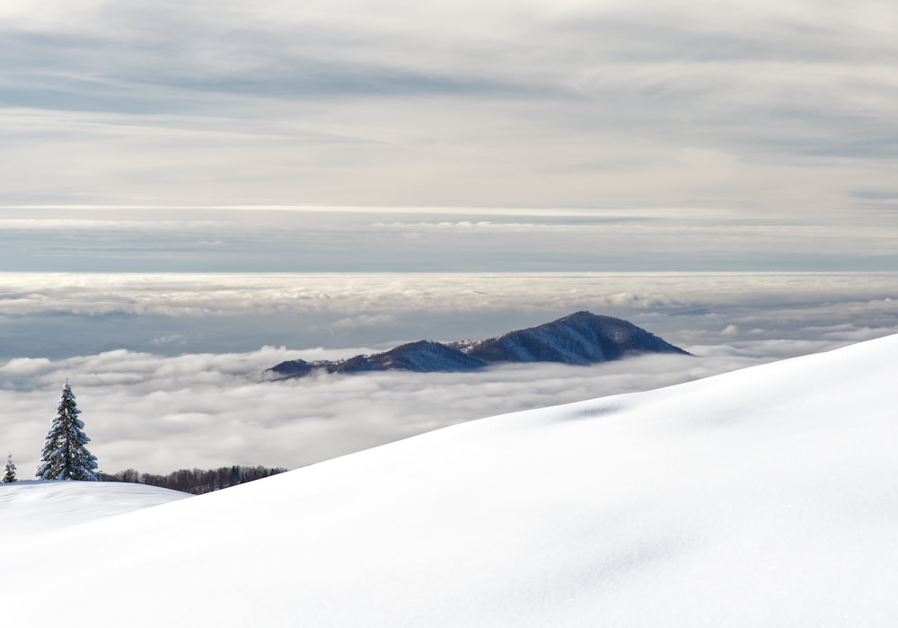 a person on skis standing on top of a snow covered mountain