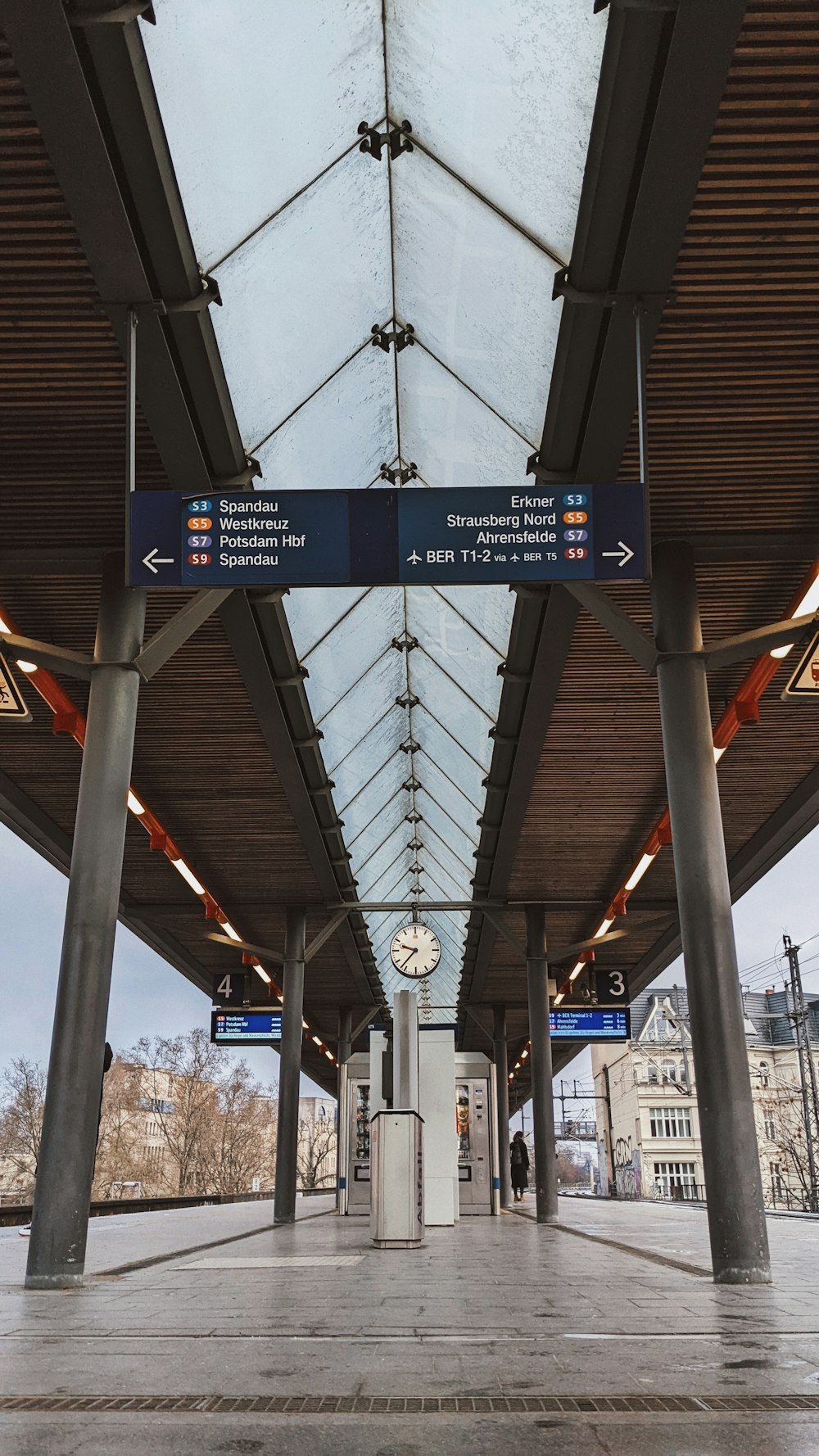 a train station with a clock and a skylight