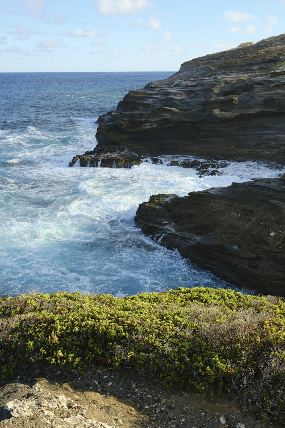 a view of the ocean from the top of a cliff