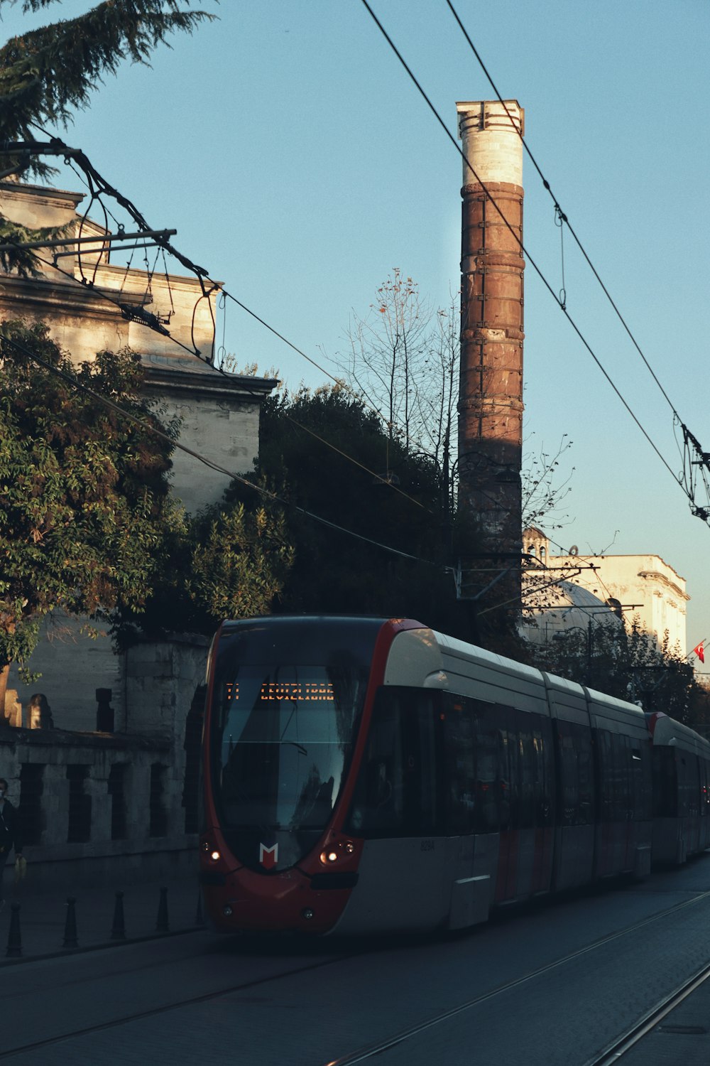 a red and white train traveling down train tracks