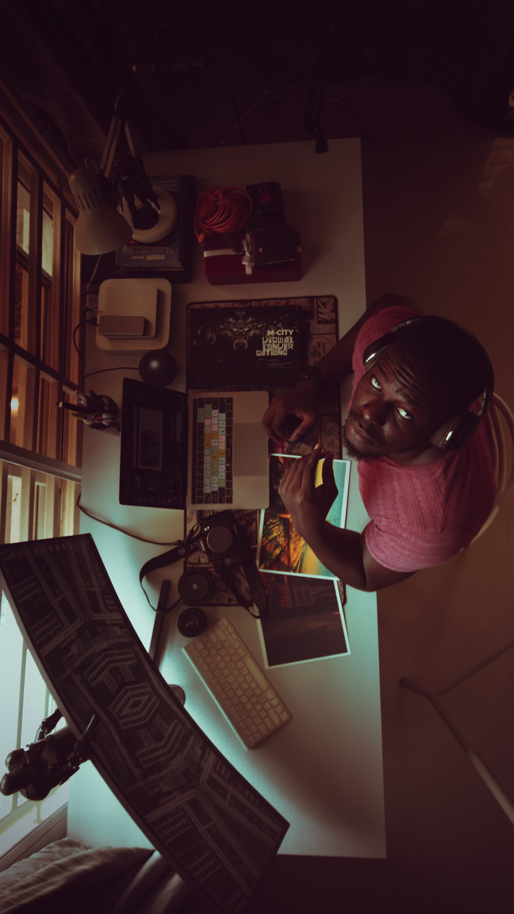 a man sitting at a desk with headphones on