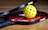 a yellow tennis ball sitting on top of a racket
