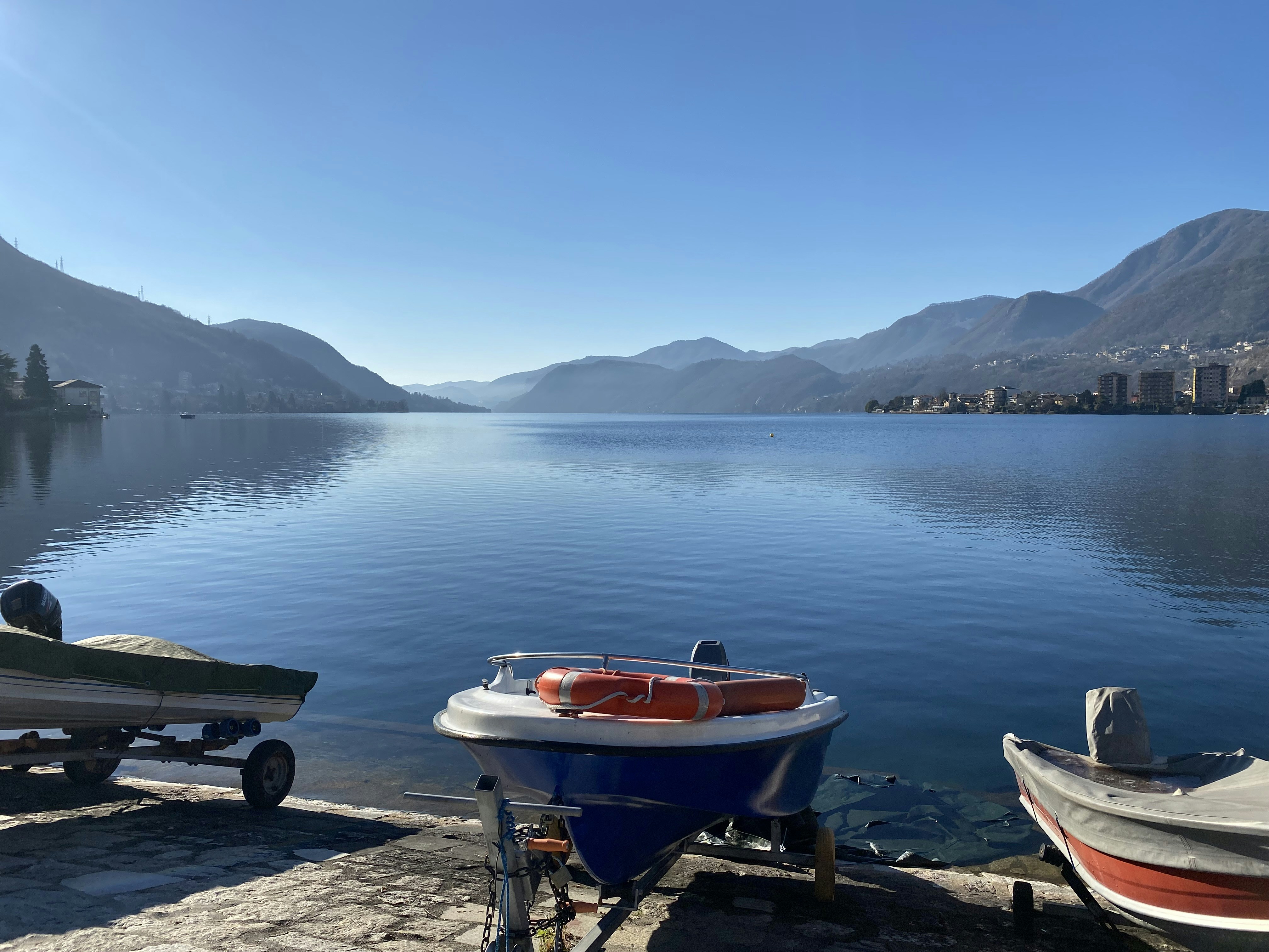 a couple of boats sitting on top of a lake
