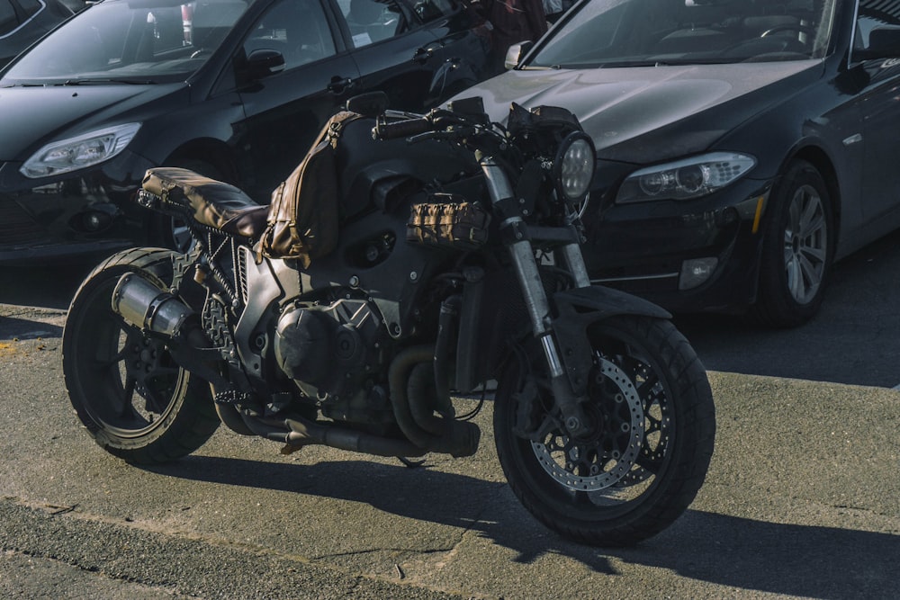 a motorcycle parked in a parking lot next to other cars