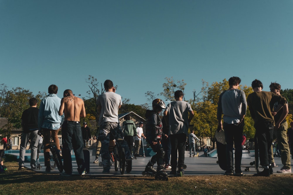 a group of skateboarders are standing in a row