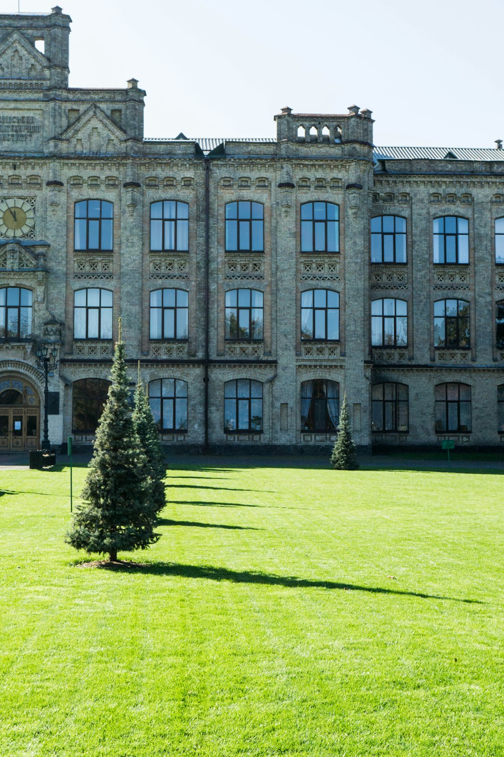 a large building with a lawn in front of it