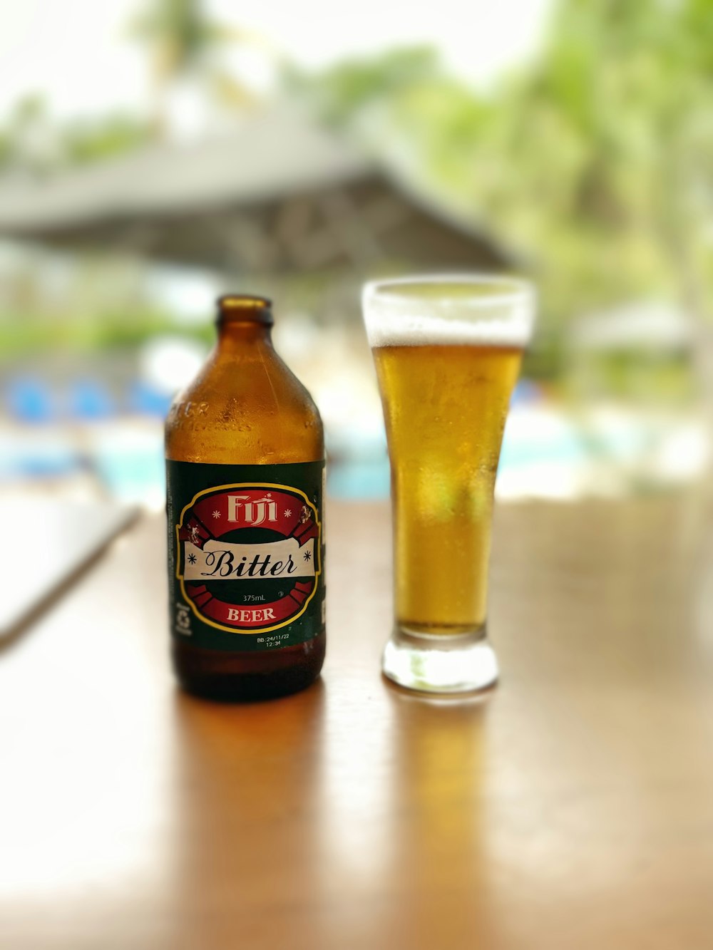 a bottle of beer next to a glass on a table