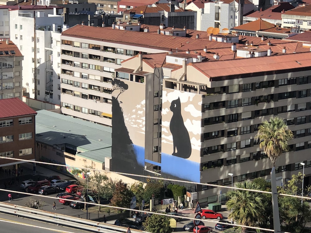 a large building with a giant cat on it's side