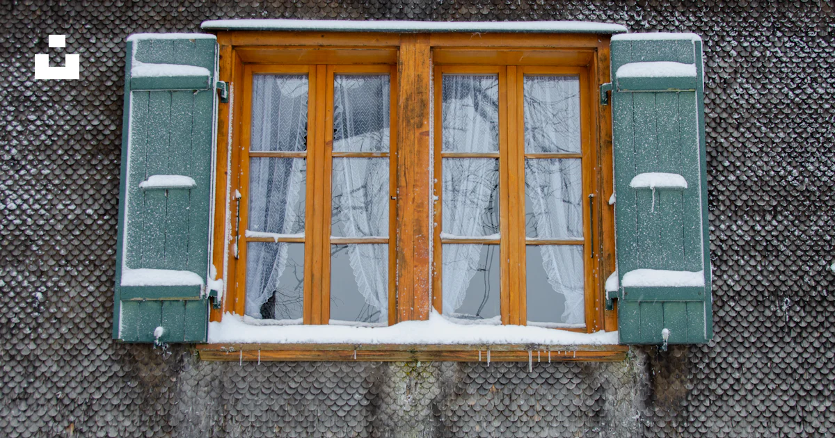 A window with a curtain and snow on the window sill photo – Free House ...