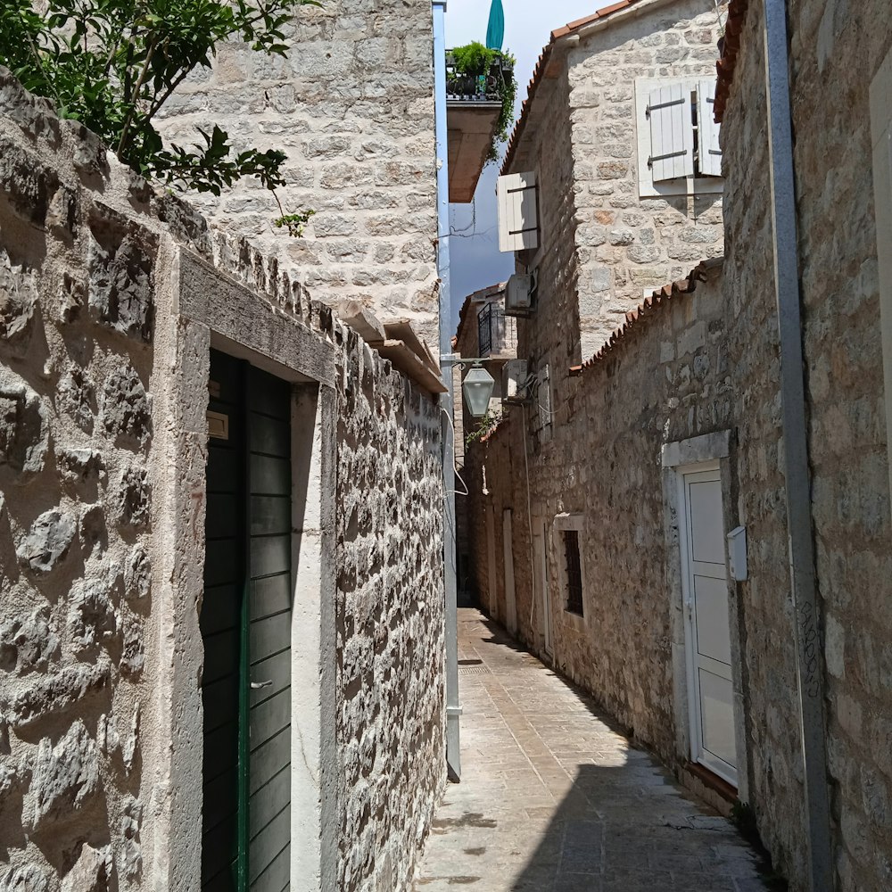 a narrow alley with a clock tower in the background