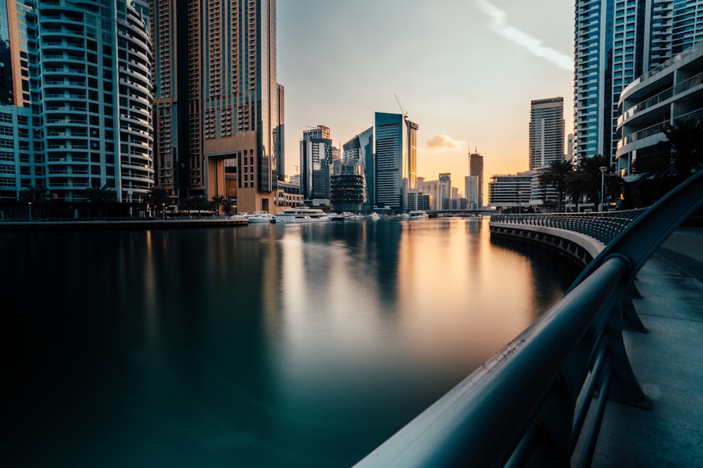 a bridge over water with a city in the background