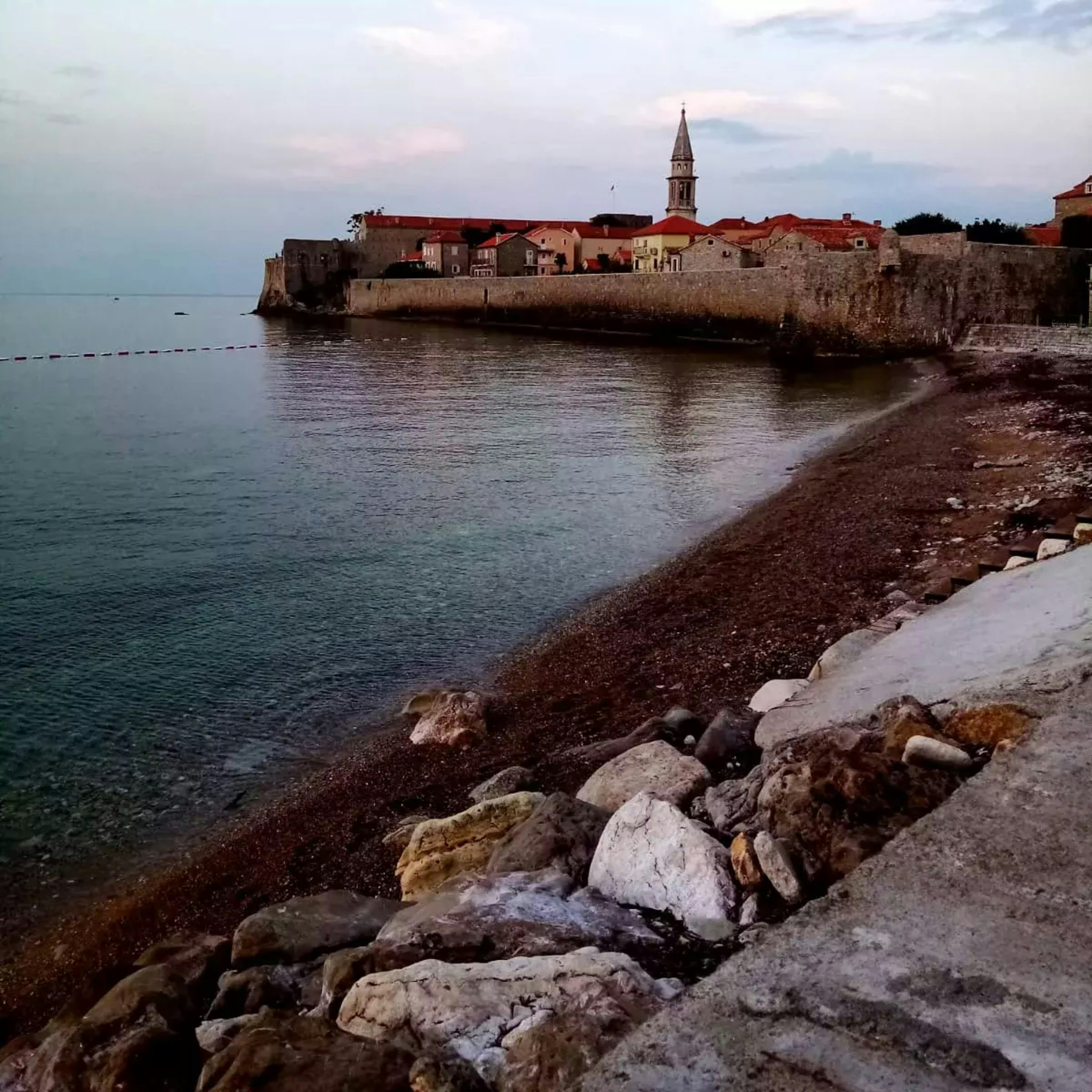 a view of a beach with a castle in the background