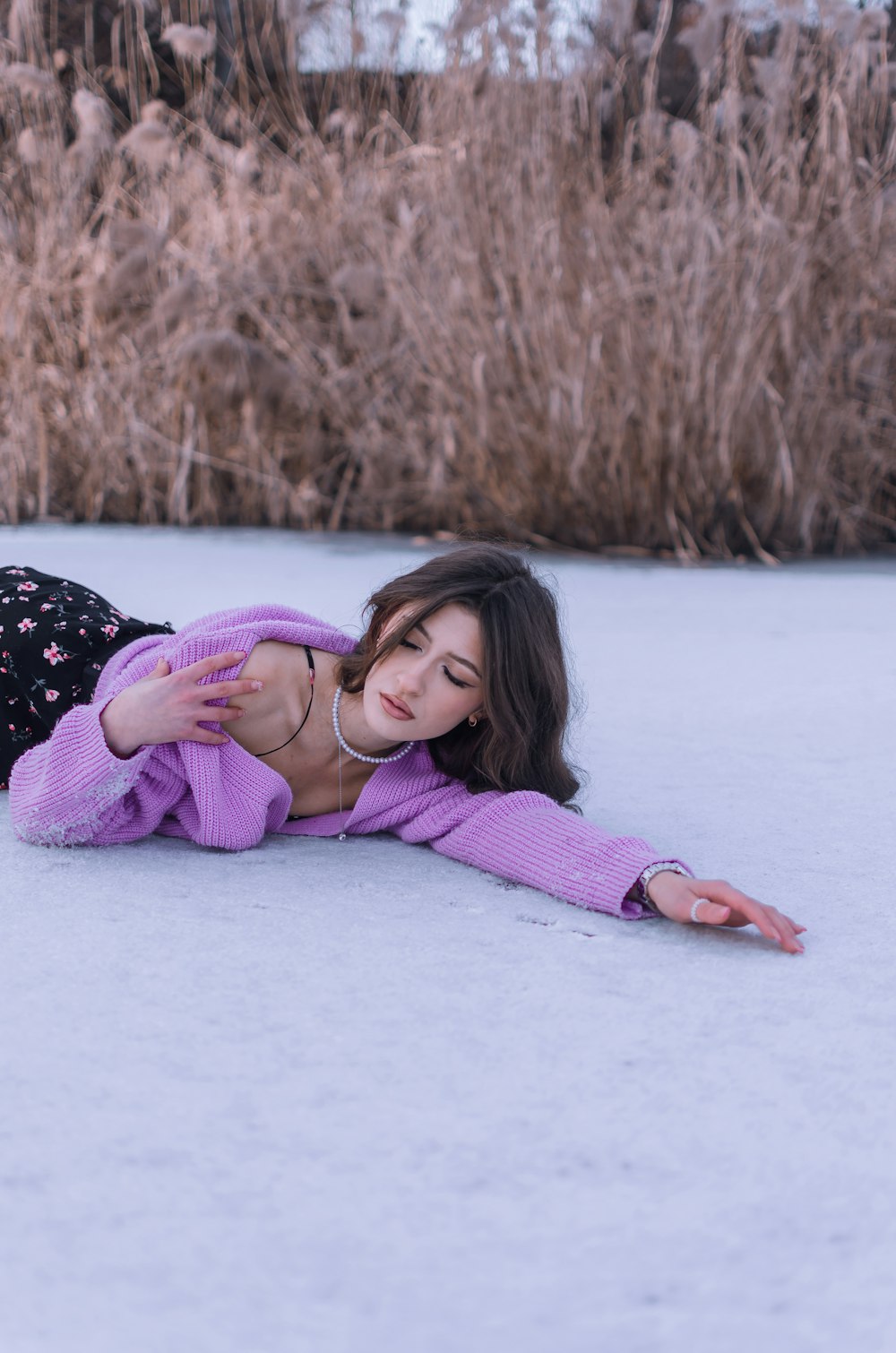 a woman laying on the ground in the snow