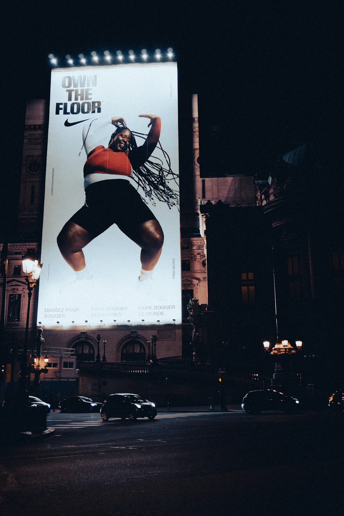 Digital advertising screens in a city at night