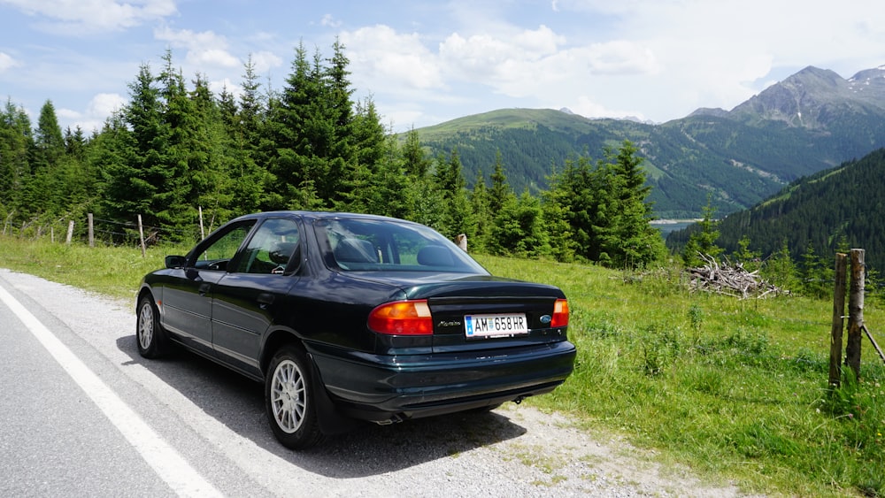 a black car parked on the side of a road