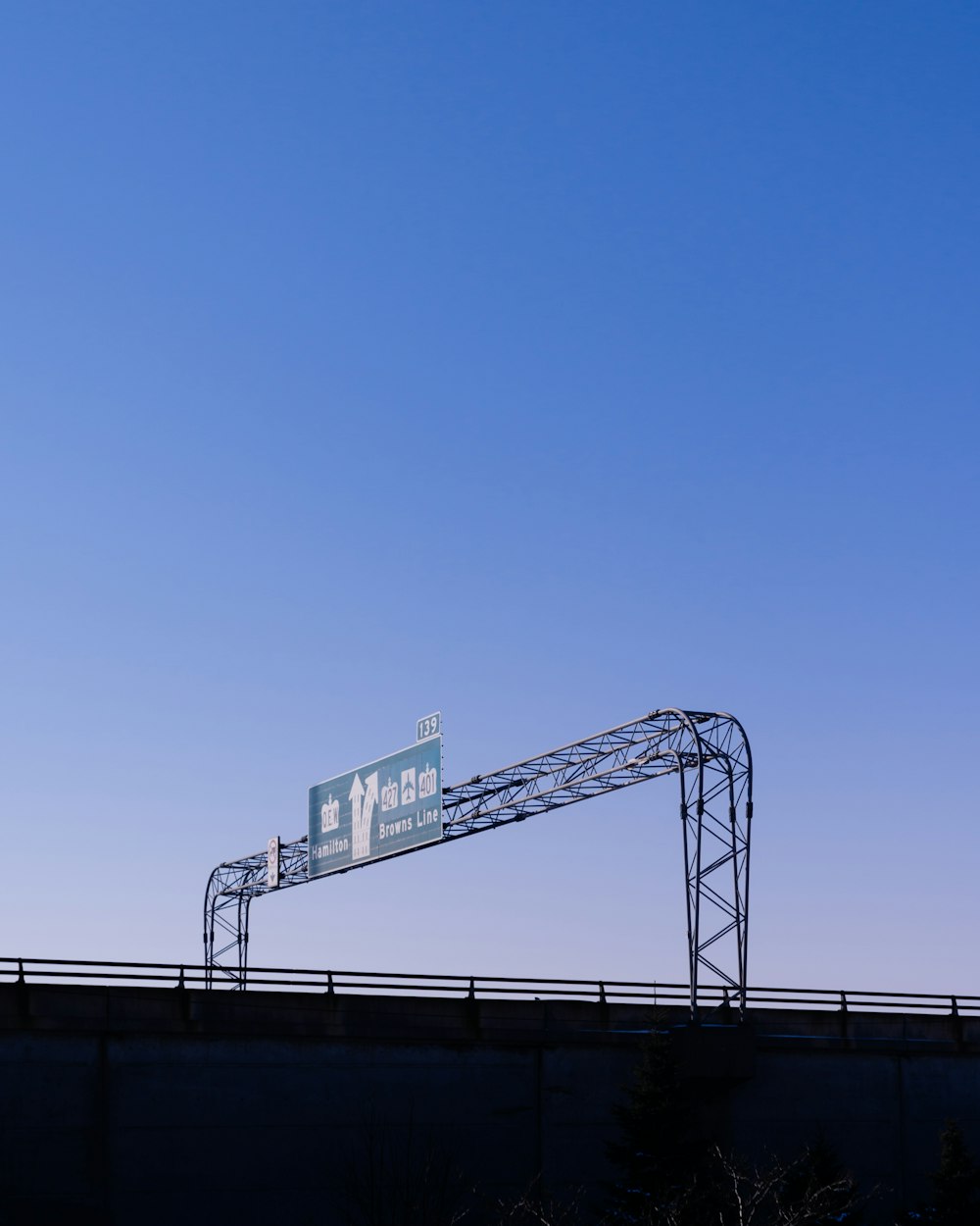 a highway sign on top of a bridge