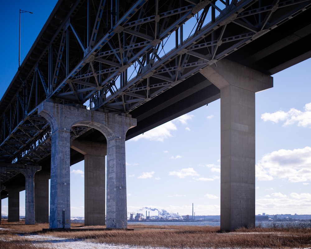 the underside of a bridge over a body of water