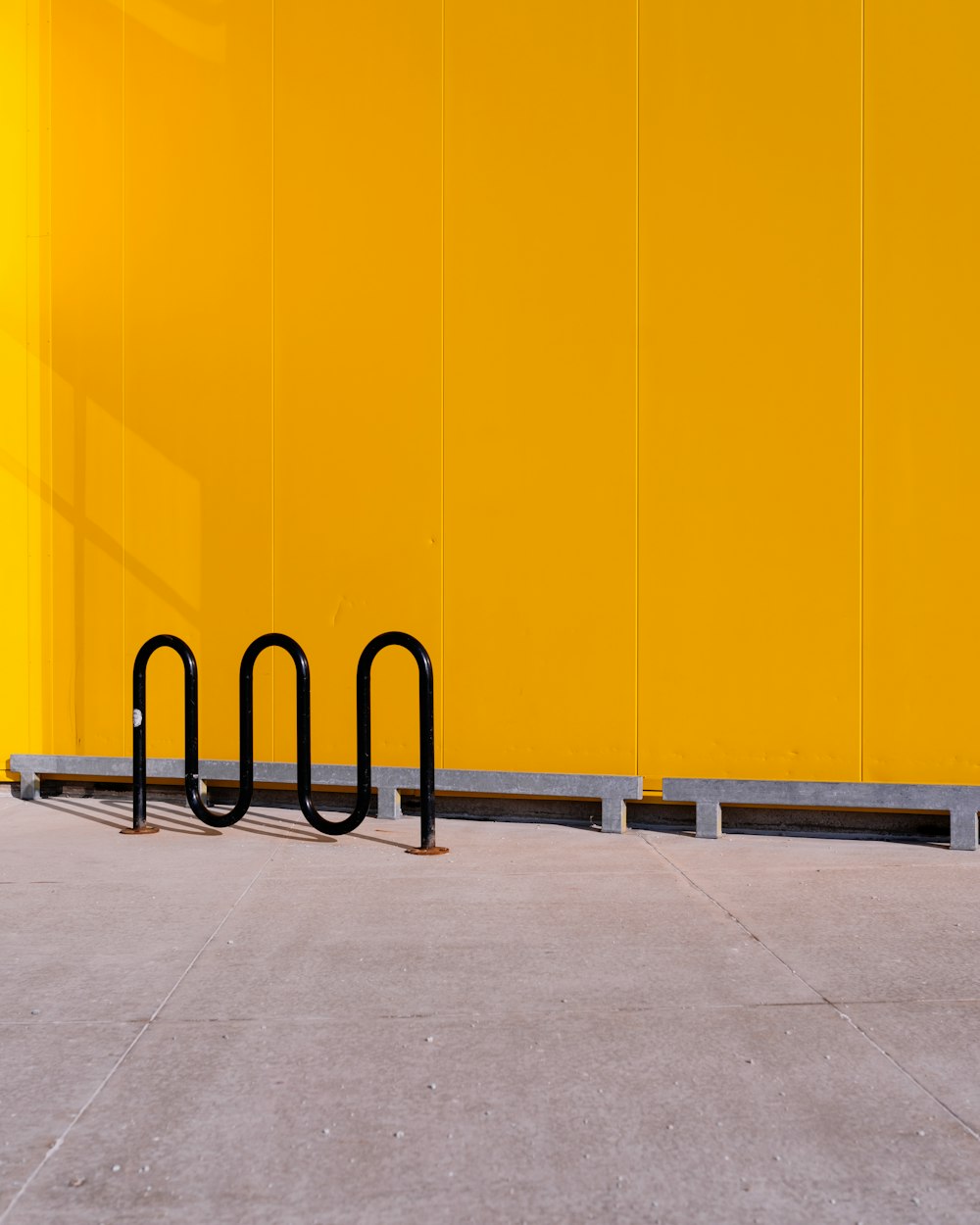 a yellow wall with three black bars on it