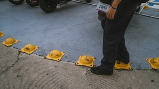 a man standing on a sidewalk next to a parking meter