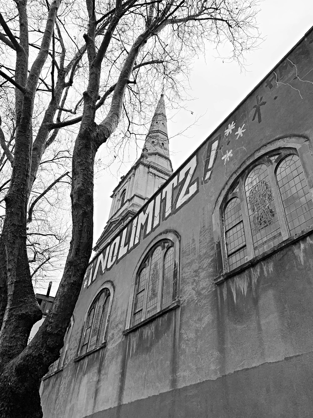 a black and white photo of a building with a clock tower