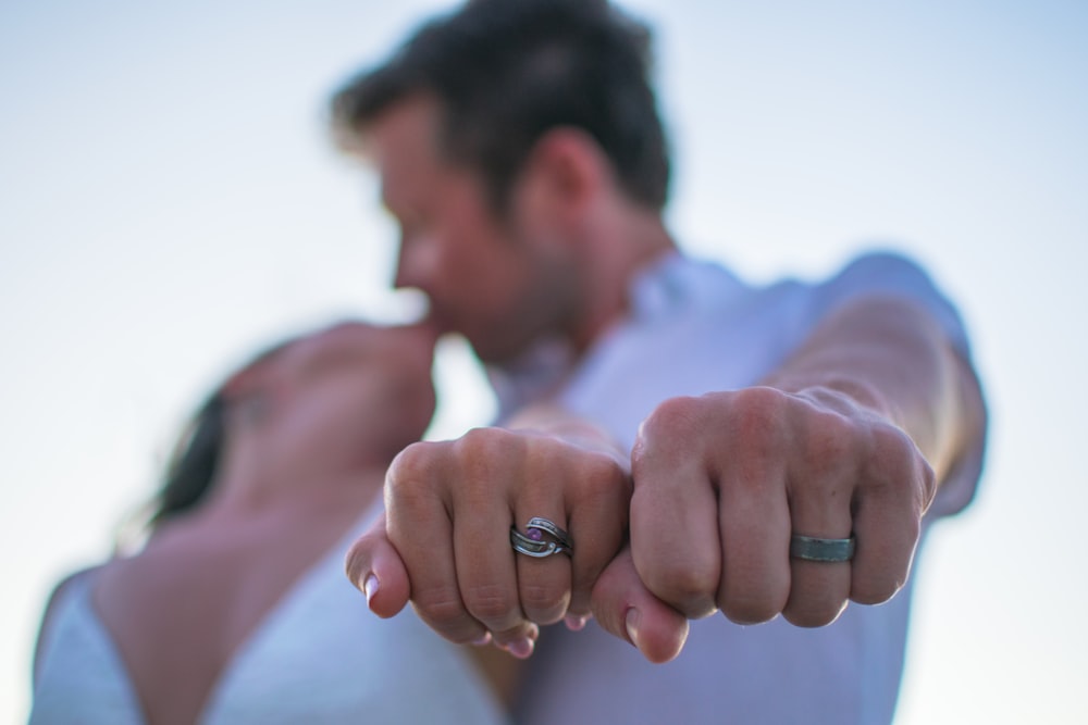 a man and a woman holding their hands together