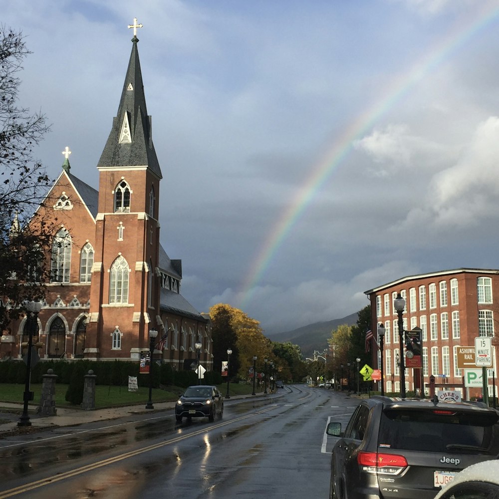 a church with a rainbow in the background