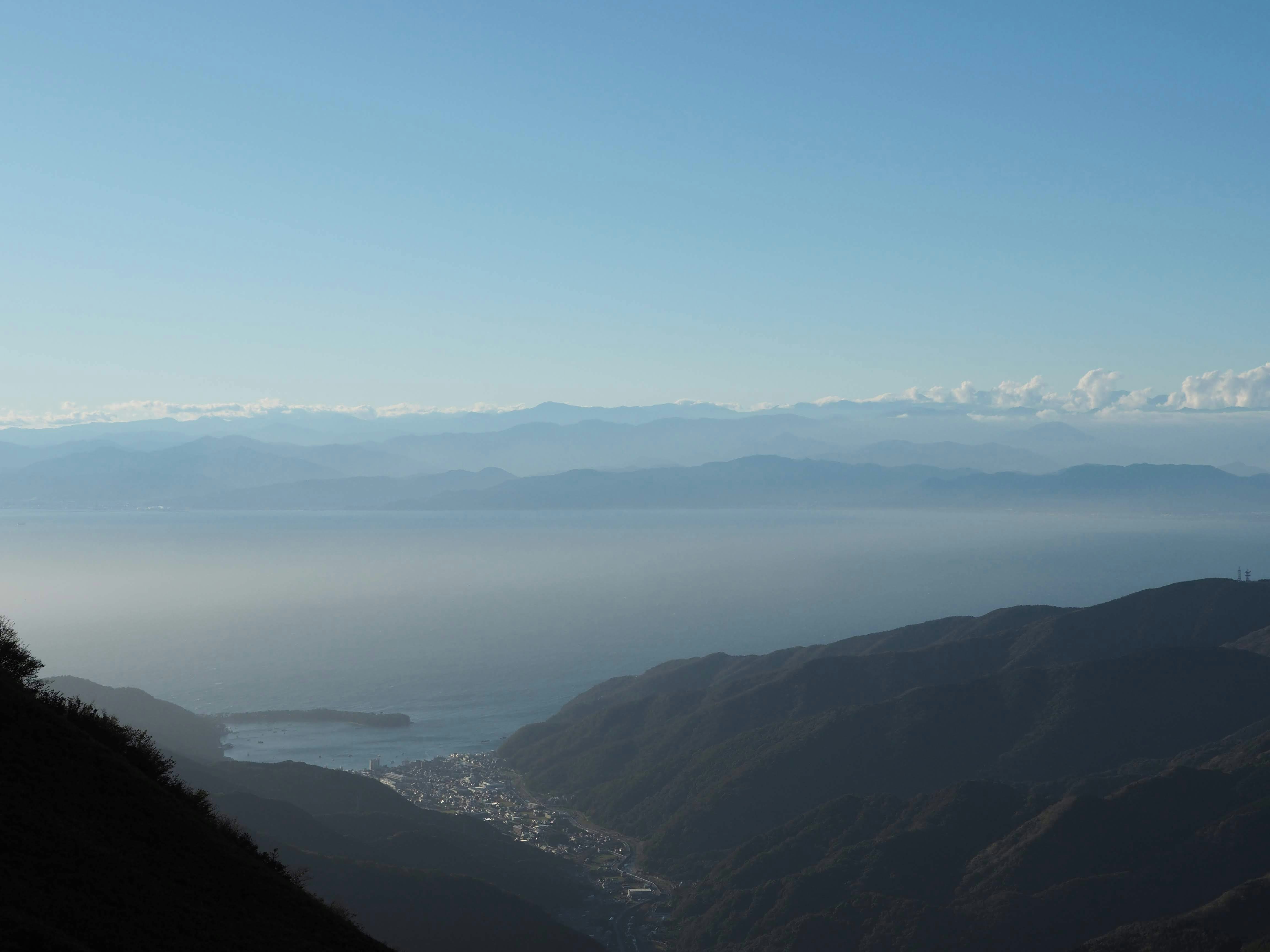 a view of a valley with mountains in the background