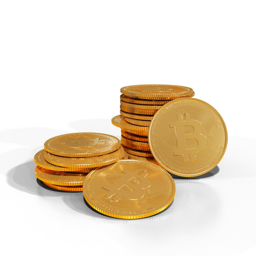 a pile of gold bitcoins sitting on top of each other