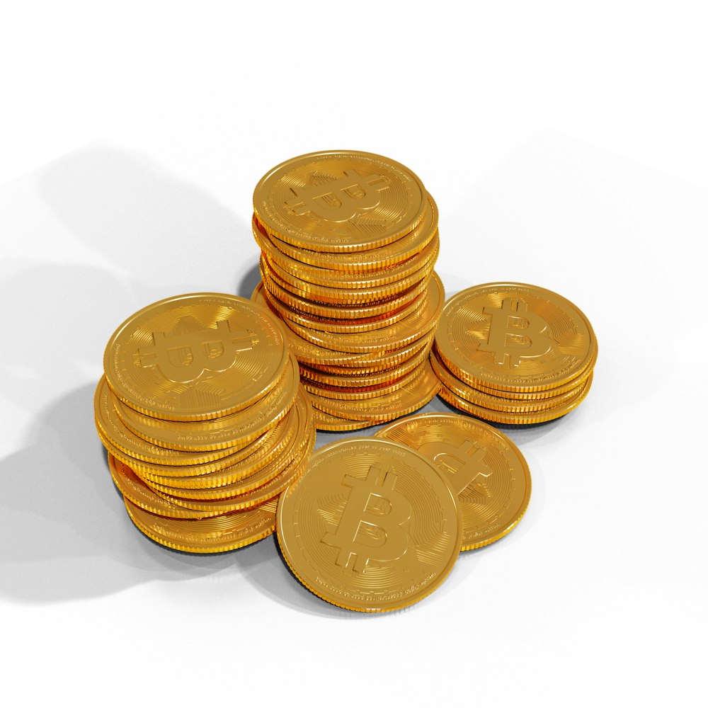 a pile of gold bitcoins sitting on top of each other