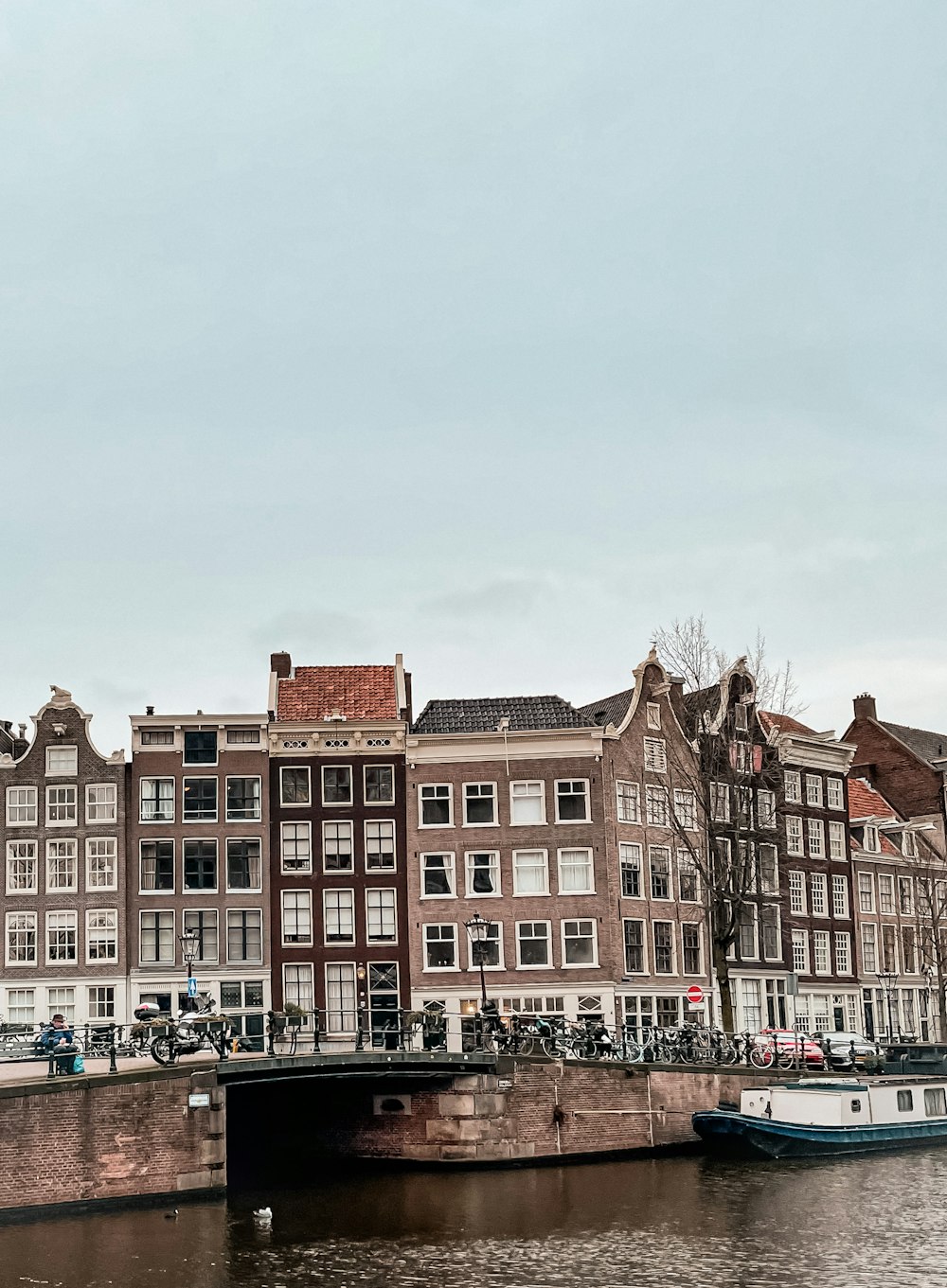 a bridge over a body of water next to a row of buildings