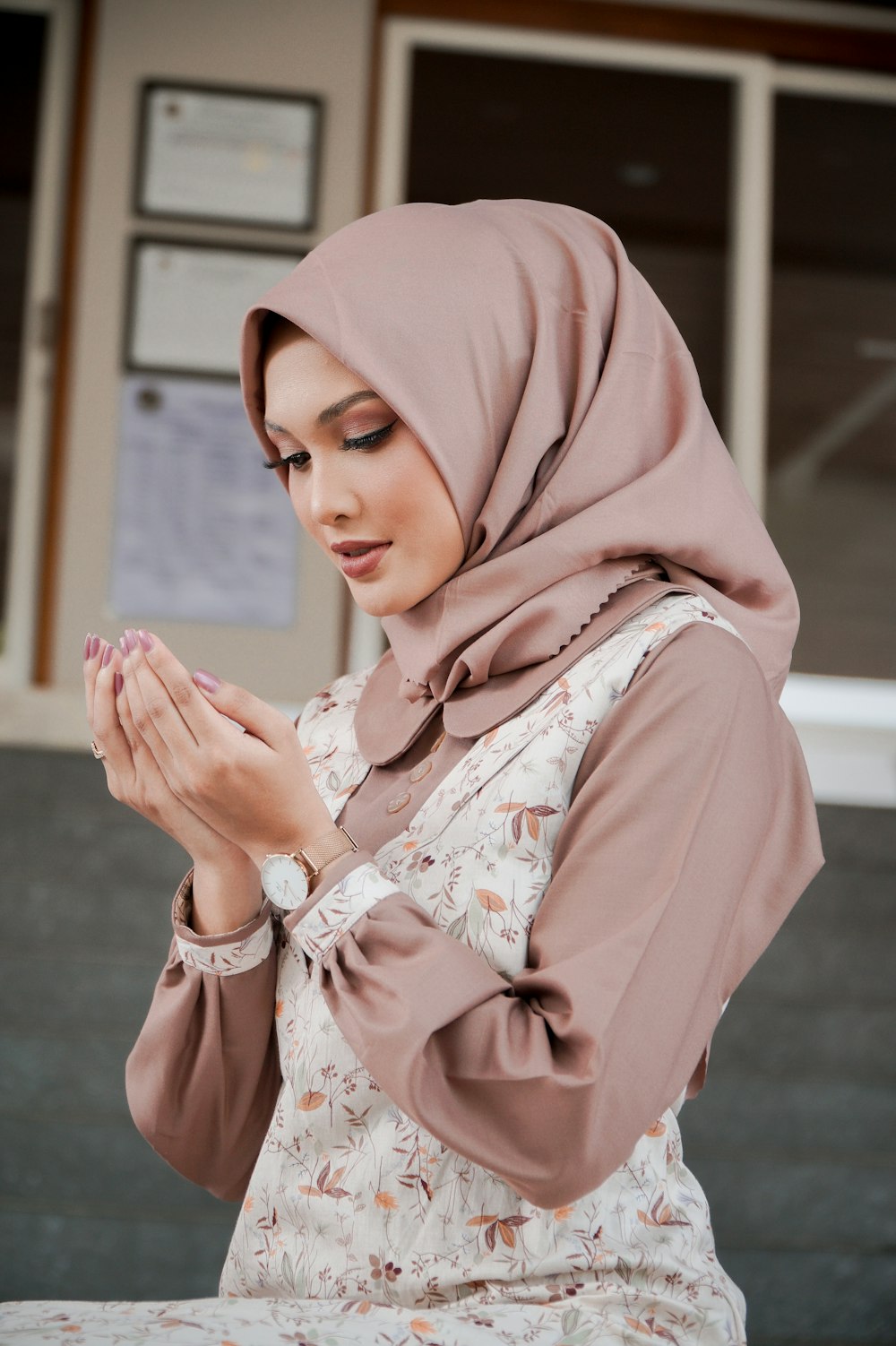 a woman in a hijab is praying