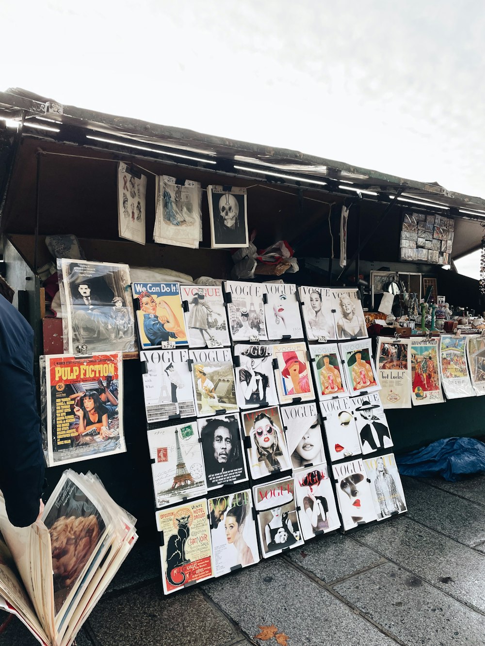 a man reading a newspaper in front of a store