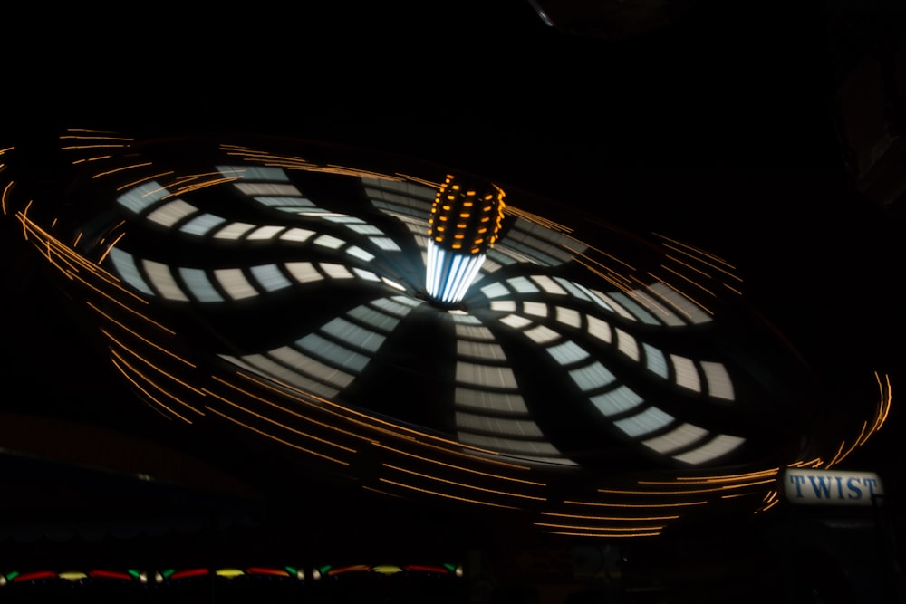 a ferris wheel spinning at night with lights