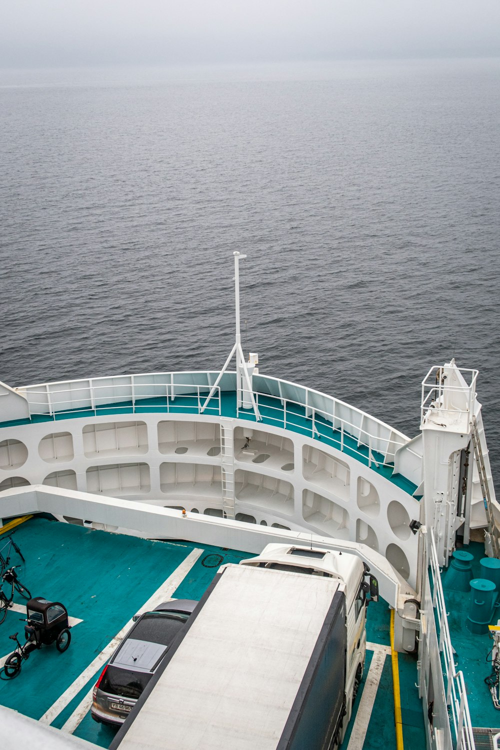 a car is parked on the deck of a boat