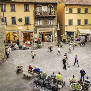 a group of people walking around a courtyard