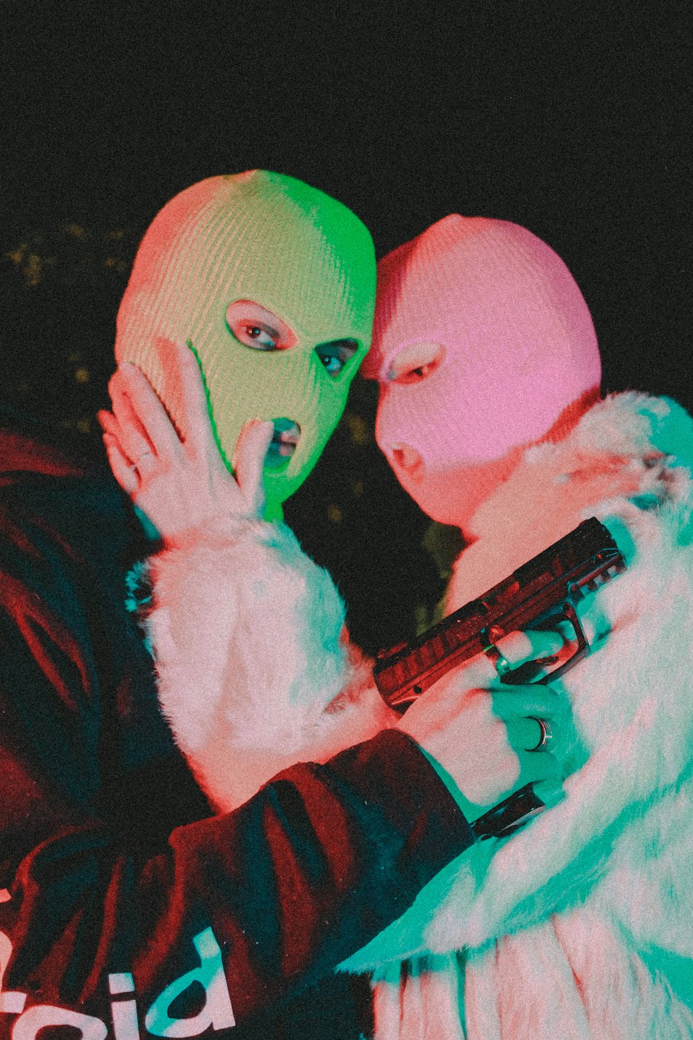 a man and a woman wearing neon masks
