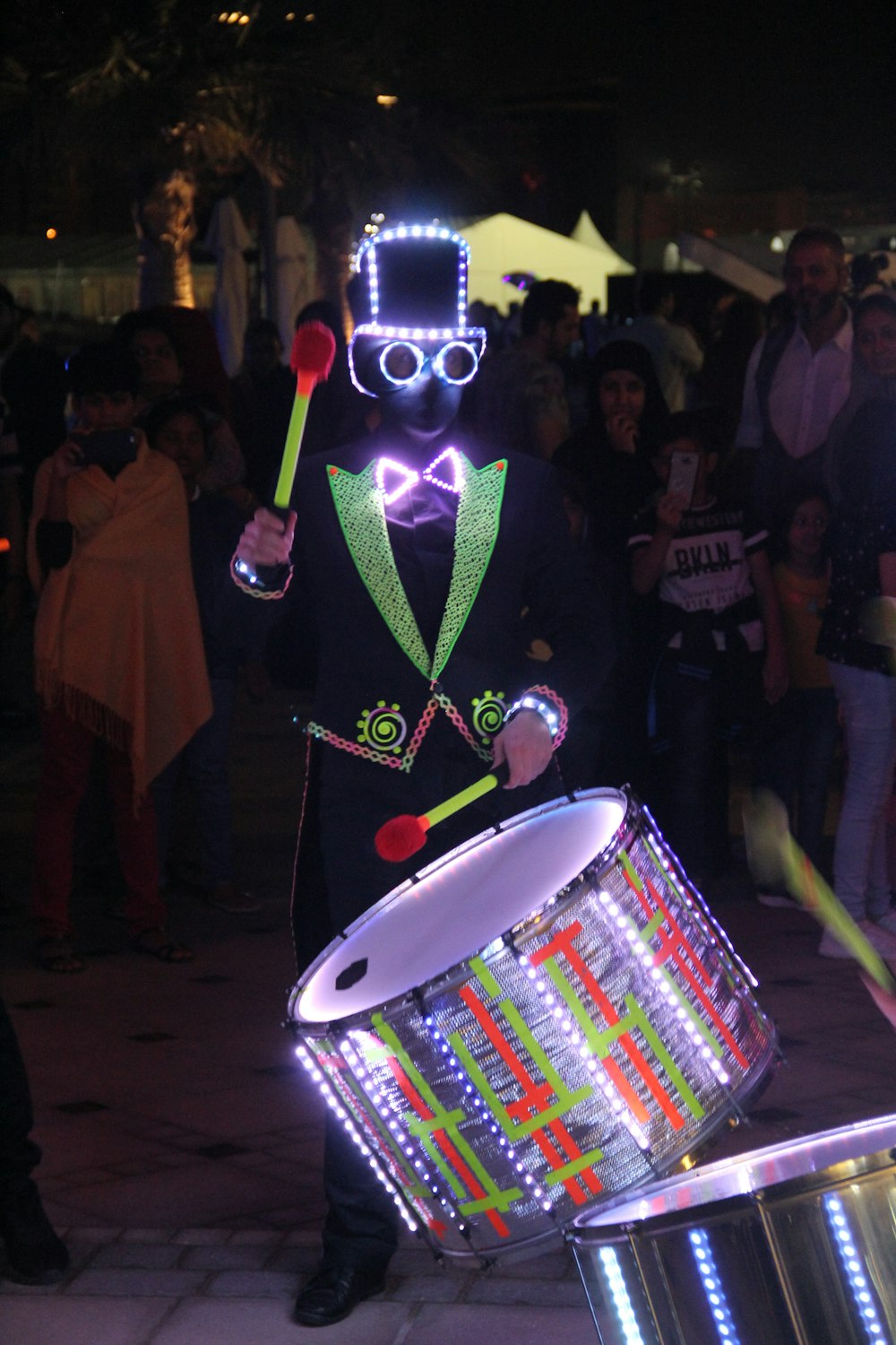 a man in a costume holding a drum