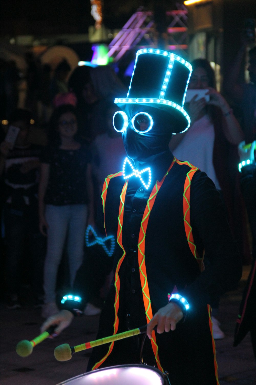 a man in a top hat and vest with lights on